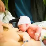 Image of woman breastfeeding a newborn baby tips to make breastfeeding easier