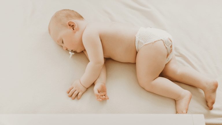 baby in a diaper laying in a crib sleeping overnight diapers for heavy wetters toddlers
